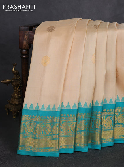 Pure gadwal silk saree cream and teal green with allover zari woven buttas and temple design zari woven border