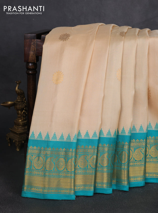 Pure gadwal silk saree cream and teal green with allover zari woven buttas and temple design zari woven border
