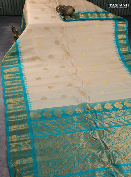 Pure gadwal silk saree cream and teal green with allover zari woven buttas and temple design zari woven border