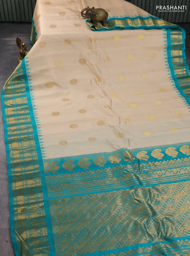 Pure gadwal silk saree cream and teal green with allover zari woven buttas and temple design zari woven border