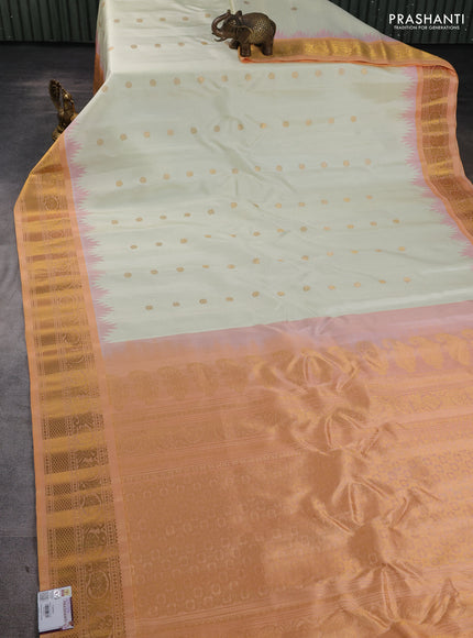 Pure gadwal silk saree cream and peach shade with allover zari woven buttas and temple design zari woven border
