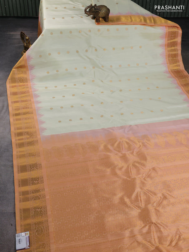 Pure gadwal silk saree cream and peach shade with allover zari woven buttas and temple design zari woven border