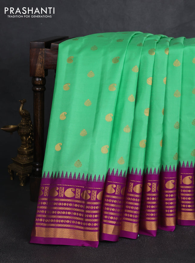 Pure gadwal silk saree teal green and purple with zari woven buttas and temple design zari woven border