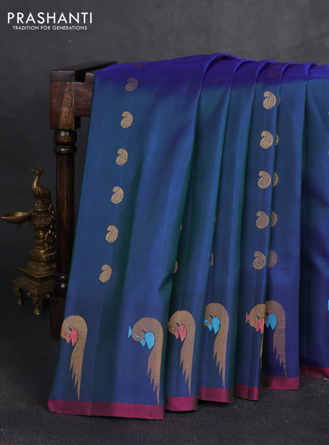Pure gadwal silk saree dual shade of bluish green and pink with allover zari woven buttas and peacock zari woven butta border