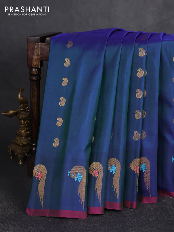 Pure gadwal silk saree dual shade of bluish green and pink with allover zari woven buttas and peacock zari woven butta border