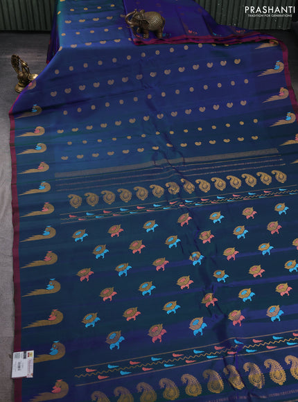 Pure gadwal silk saree dual shade of bluish green and pink with allover zari woven buttas and peacock zari woven butta border