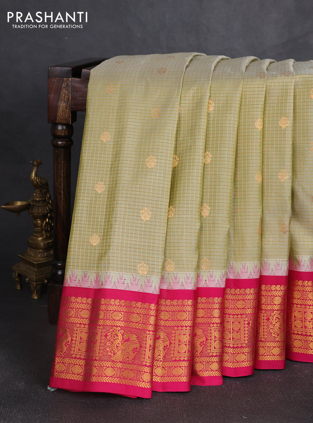 Pure gadwal silk saree elachi green and tomato pink with allover zari checks & buttas and temple design zari woven border