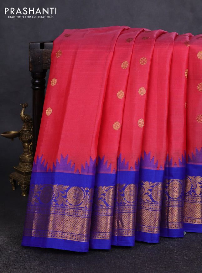 Pure gadwal silk saree tomato pink and blue with allover zari woven buttas and temple design zari woven border