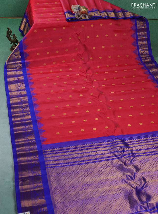 Pure gadwal silk saree tomato pink and blue with allover zari woven buttas and temple design zari woven border