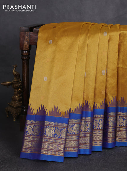 Pure gadwal silk saree mustard yellow and cs blue with allover silver & gold zari woven buttas and temple design zari woven border