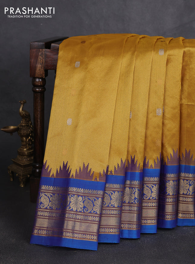 Pure gadwal silk saree mustard yellow and cs blue with allover silver & gold zari woven buttas and temple design zari woven border