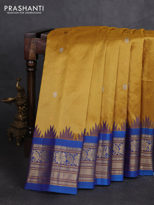 Pure gadwal silk saree mustard yellow and cs blue with allover silver & gold zari woven buttas and temple design zari woven border