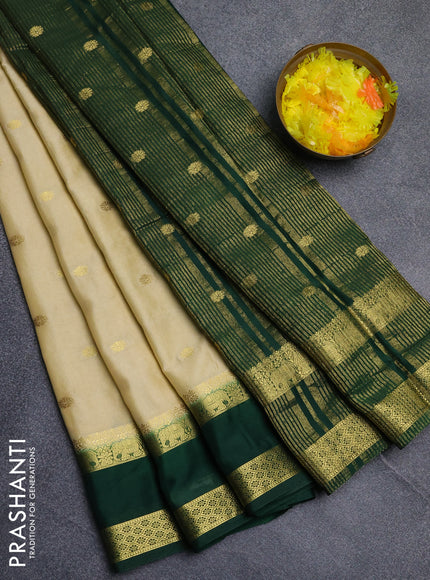 Semi mysore silk saree cream and bottle green with allover zari woven buttas and rettapet zari woven border