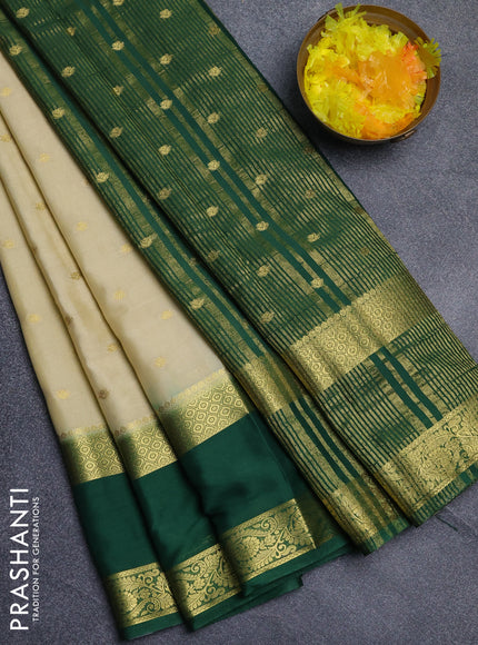 Semi mysore silk saree cream and bottle green with allover zari woven buttas and long rettapet zari woven border