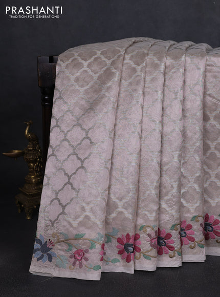 Art tissue saree pastel pink shade with allover zari woven brocade weaves and embroidery work border