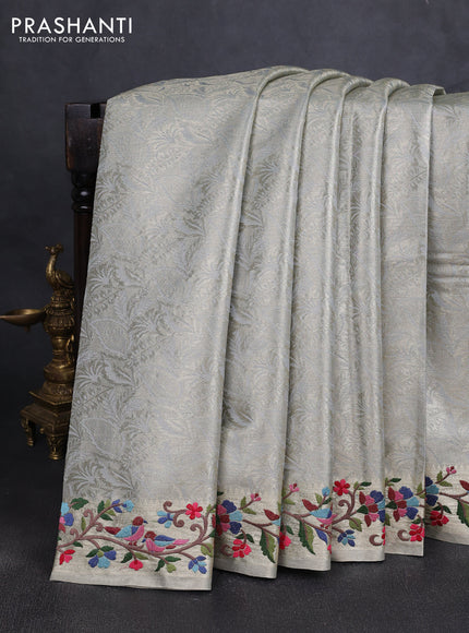 Art tissue silk sare pastel grey with allover brocade weaves and embroidery work border