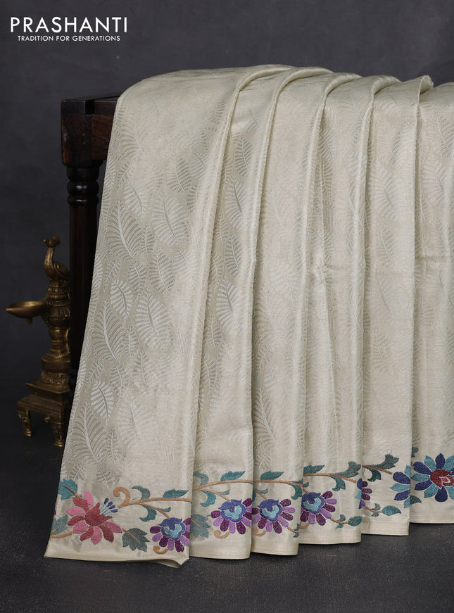 Tissue silk sare off white and pink rust shade with allover brocade weaves and embroidery work border