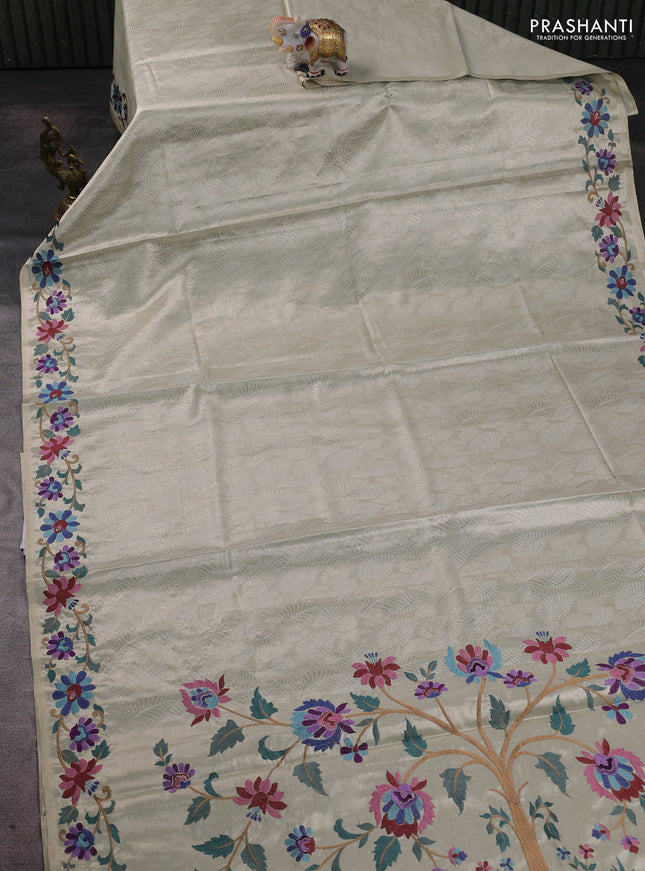 Tissue silk sare off white and pink rust shade with allover brocade weaves and embroidery work border