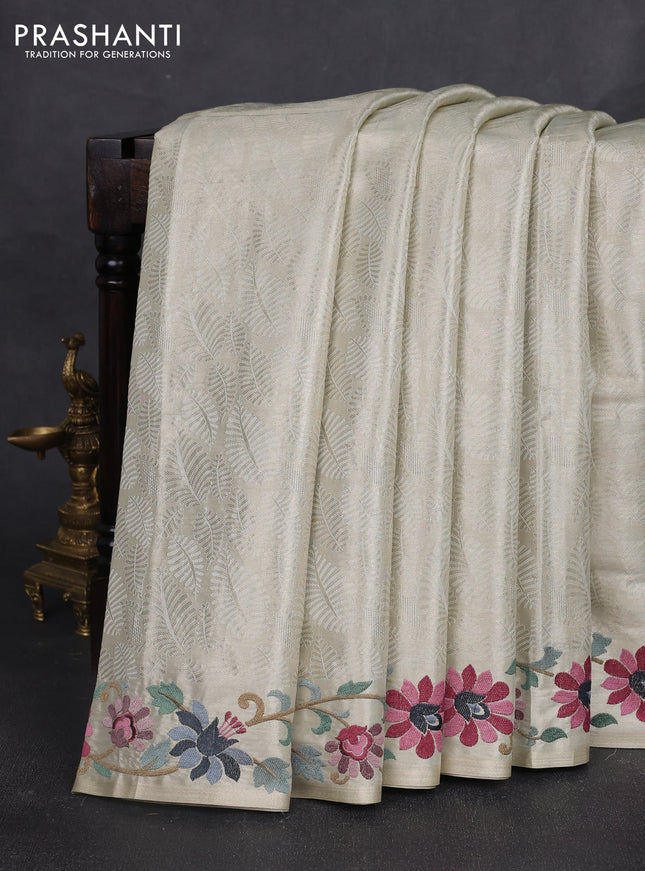 Tissue silk sare off white and grey black with allover brocade weaves and embroidery work border