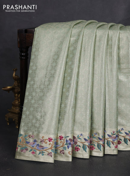 Art tissue silk sare pista green with allover brocade weaves and embroidery work border