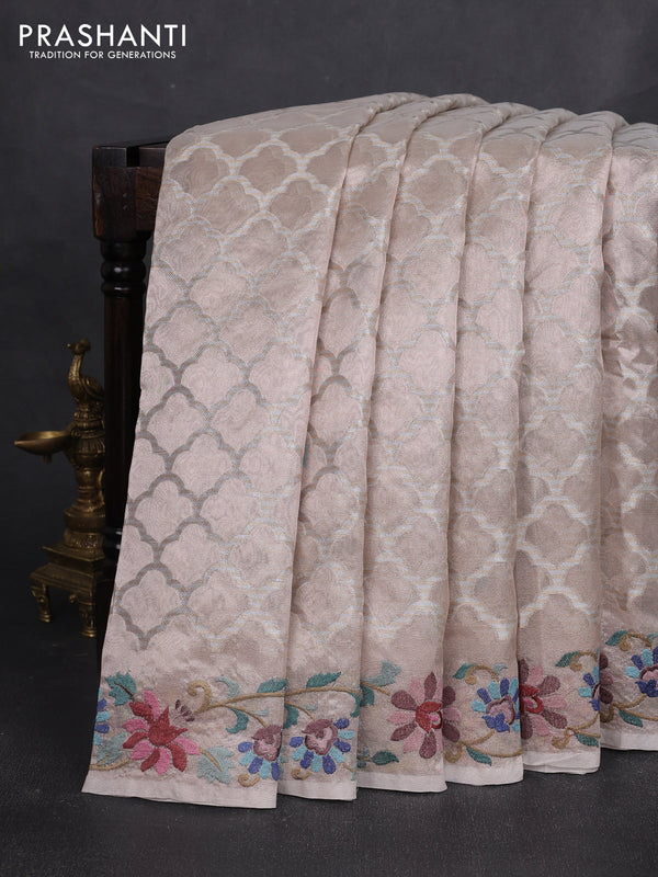 Art tissue silk sare pastel pink shade with allover brocade weaves and embroidery work border