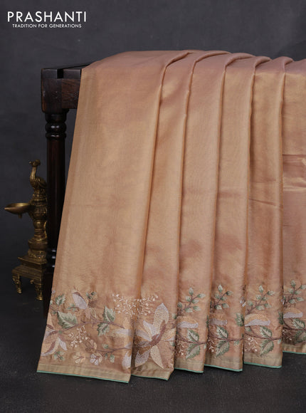 Art tissue silk sare golden peach and pastel green with plain body and embroidery work border