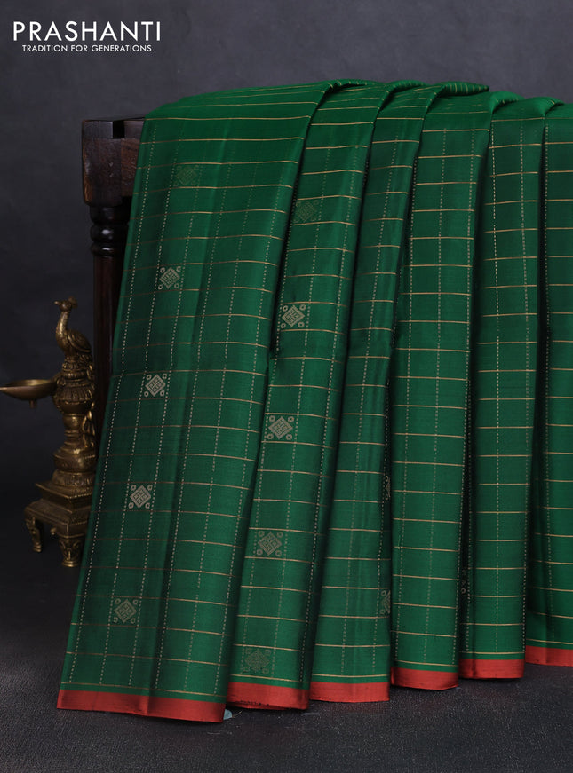 Pure soft silk saree green and rustic orange with allover zari checks & buttas and piping border