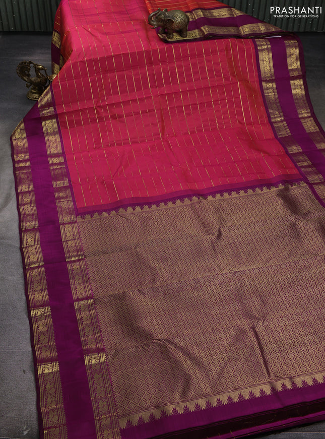 Pure kanchipuram silk saree dual shade of pinkish orange and purple with allover zari weaves and rettapet zari woven border