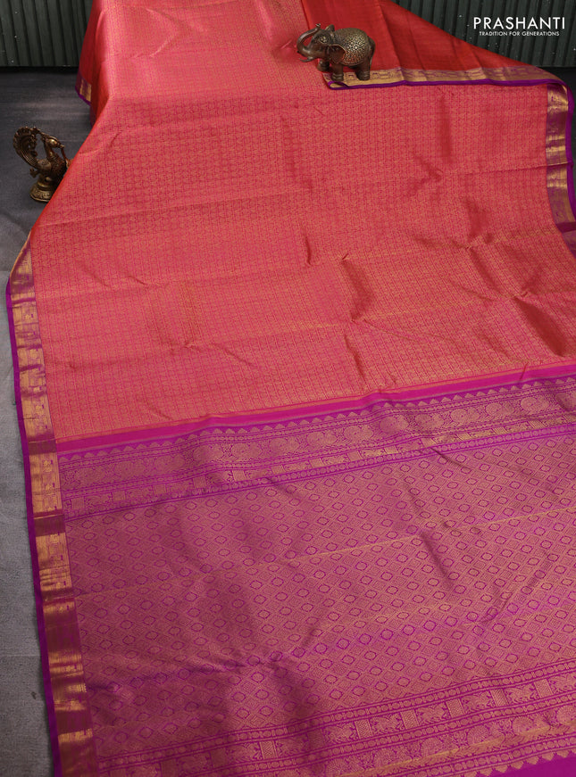 Pure kanchipuram silk saree dual shade of pinkish orange and purple with allover zari woven brocade weaves and zari woven border