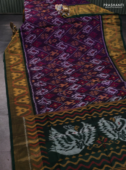 Ikat silk cotton saree deep violet and bottle green with allover ikat weaves and long ikat woven zari border