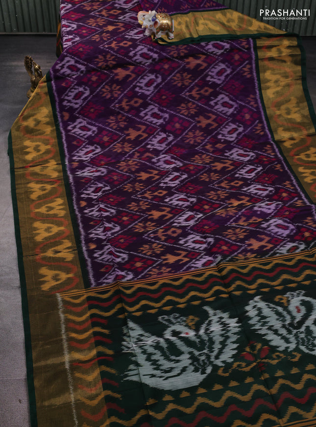 Ikat silk cotton saree deep violet and bottle green with allover ikat weaves and long ikat woven zari border