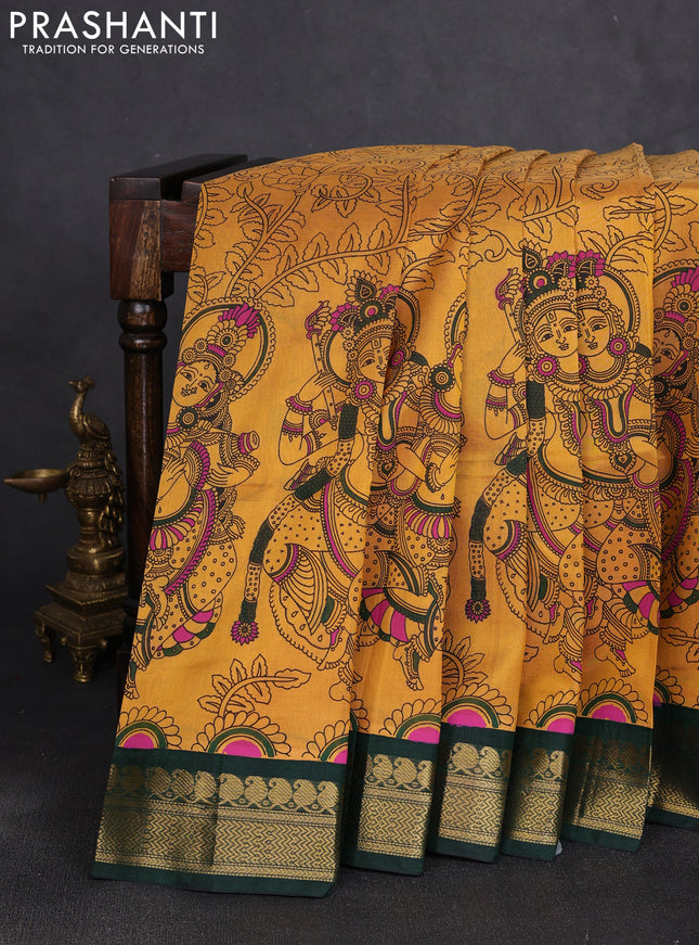 Silk cotton saree mustard yellow and bottle green with allover kalamkari prints and korvai zari woven border