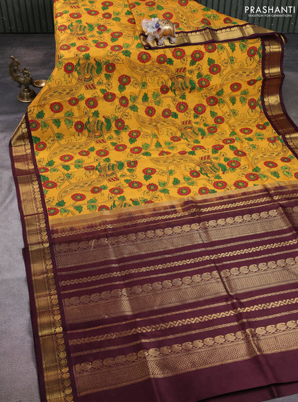 Silk cotton saree mustard yellow and deep maroon with allover kalamkari prints and korvai zari woven border