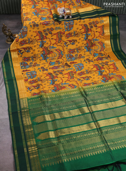 Silk cotton saree mustard yellow and bottle green with allover kalamkari prints and korvai zari woven border