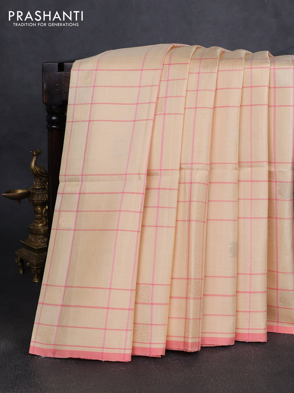 Pure soft silk saree cream and mild peach pink with allover checks & zari buttas and piping border