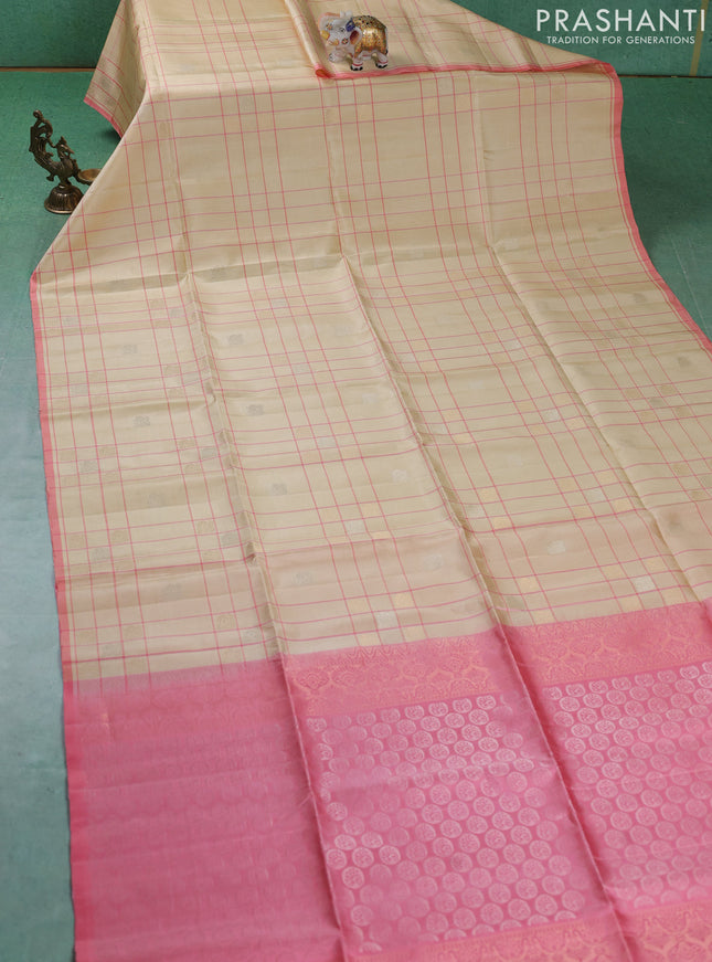 Pure soft silk saree cream and mild peach pink with allover checks & zari buttas and piping border