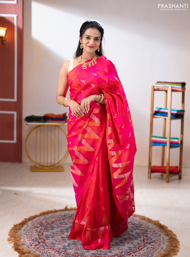 Pure uppada silk saree dual shade of pinkish orange with allover silver & zari woven buttas and long zari zigzag border