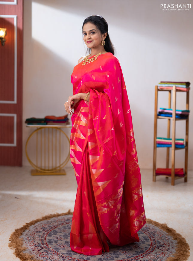 Pure uppada silk saree dual shade of pinkish orange with allover silver & zari woven buttas and long zari zigzag border