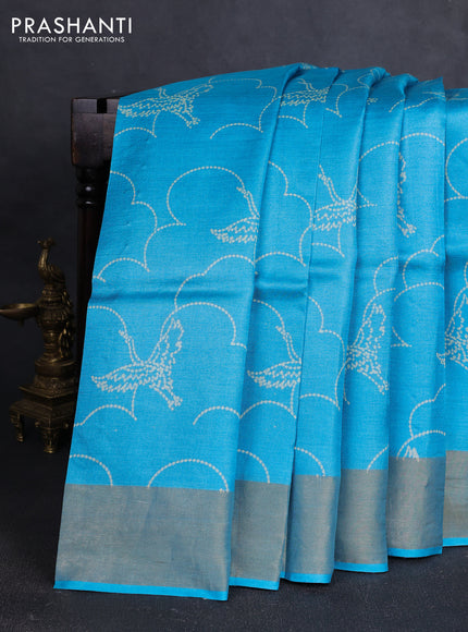 Pure tussar silk saree teal blue with allover prints and zari woven border