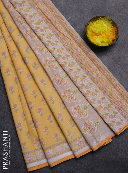 Mul cotton saree off white and mango yellow with allover butta prints and printed border