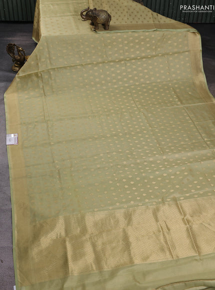 Banarasi tissue uppada silk saree pista green with allover zari woven butta weaves and zari woven border