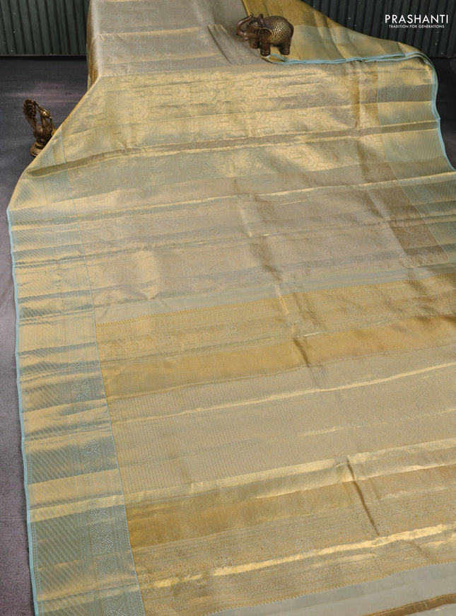 Pure kanchipuram tissue silk saree gold and mild teal blue with allover zari woven brocade weaves and rich zari woven border