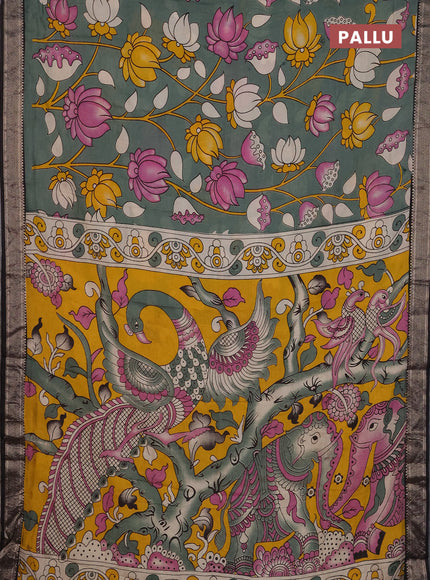 Kalamkari semi silk saree pastel green and black with allover prints and mangalgiri border
