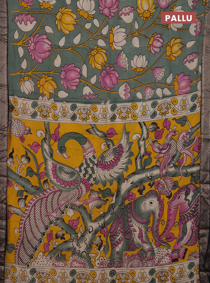 Kalamkari semi silk saree pastel green and black with allover prints and mangalgiri border