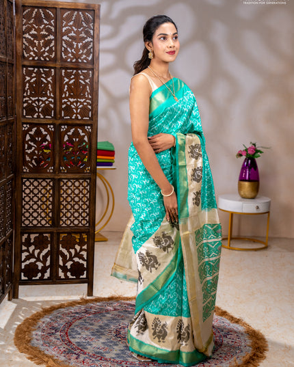 Pochampally silk saree teal green and cream with allover ikat weaves and ikat woven buttas & zari woven border