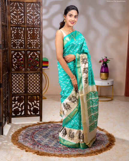 Pochampally silk saree teal green and cream with allover ikat weaves and ikat woven buttas & zari woven border