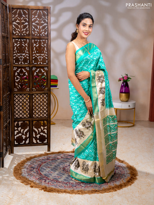 Pochampally silk saree teal green and cream with allover ikat weaves and ikat woven buttas & zari woven border