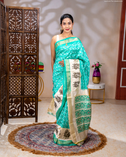 Pochampally silk saree teal green and cream with allover ikat weaves and ikat woven buttas & zari woven border