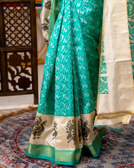 Pochampally silk saree teal green and cream with allover ikat weaves and ikat woven buttas & zari woven border