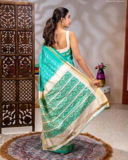 Pochampally silk saree teal green and cream with allover ikat weaves and ikat woven buttas & zari woven border